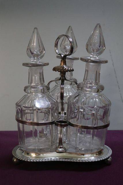 Cut Glass 3 Bottle Tantalus in a Silver Plated Stand