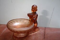 An Art Deco pink moulded glass posy bowl and stand of a kneeling female figure 