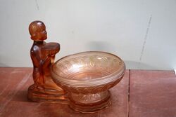 An Art Deco pink moulded glass posy bowl and stand of a kneeling female figure 