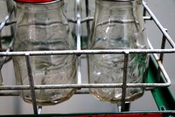 Vintage Castrol Embossed 6 Bottle Rack with Tin Tops
