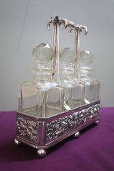 Antique Victorian Cut Glass 3 Bottle Tantalus in a Silver Plated 